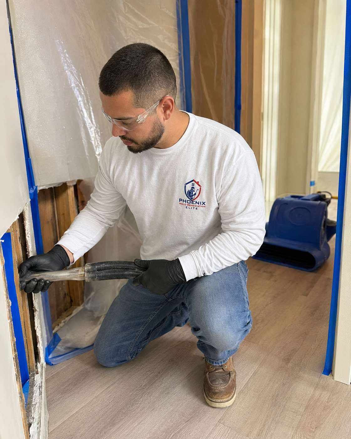 Baseboard removed exposing mold-damaged drywall